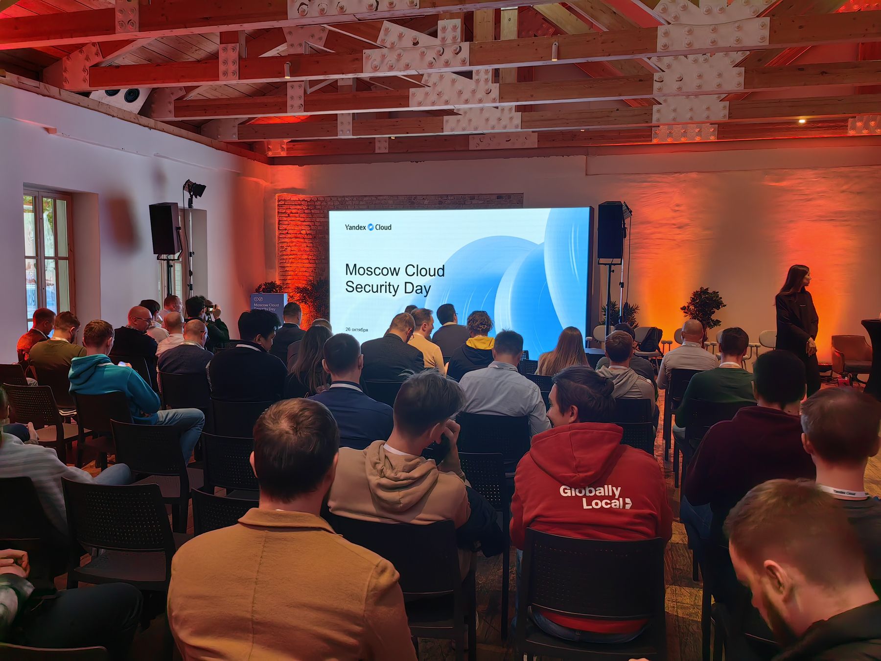 Полный зал перед началом, на экране титульный слайд Moscow Cloud Security Day, 26.10.2023